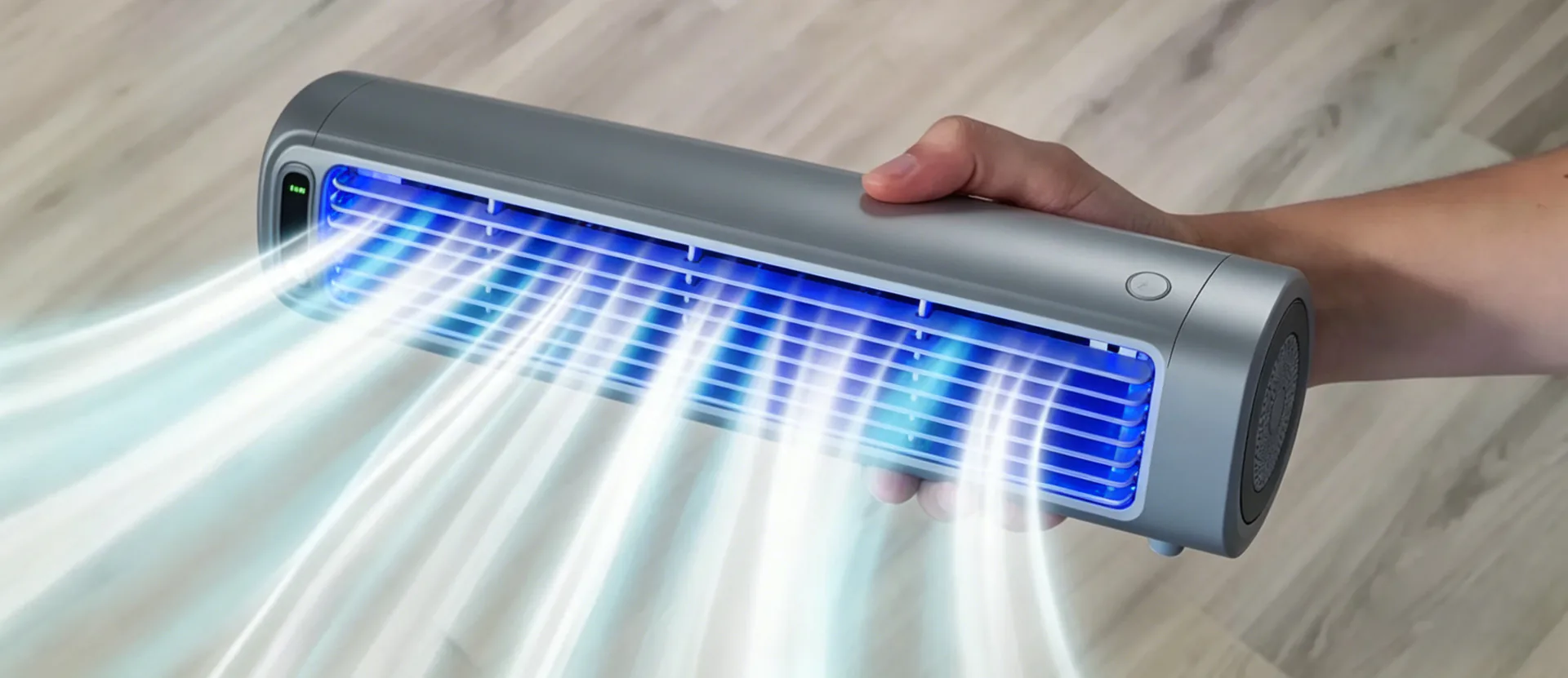 Close-up of the sleek gray nexo7 portable cooling device held in hand, with powerful illuminated blue airflow streams demonstrating fast, targeted cooling performance